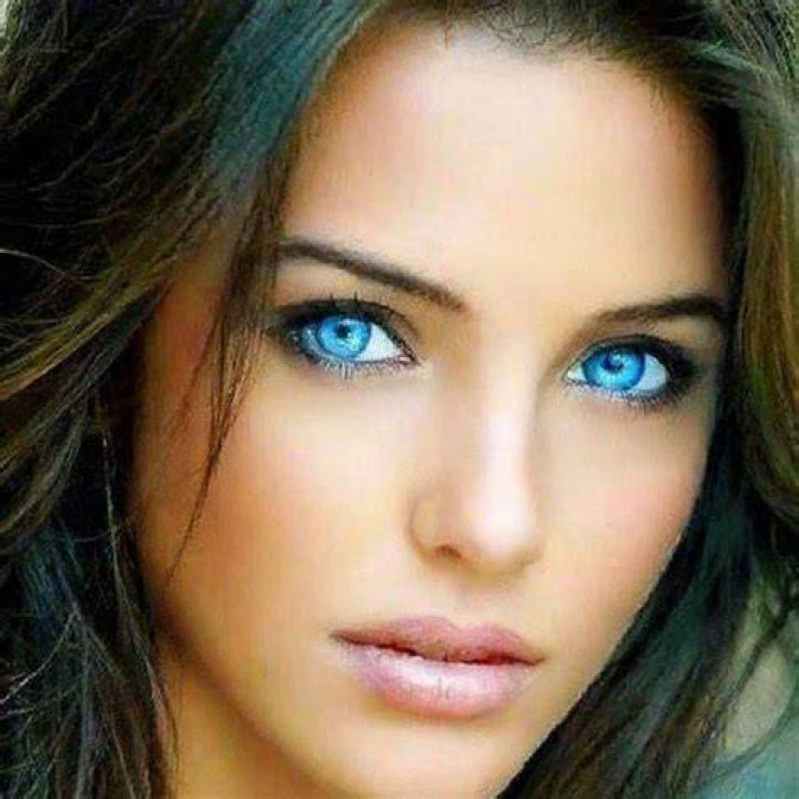 a woman with blue eyes and blonde hair