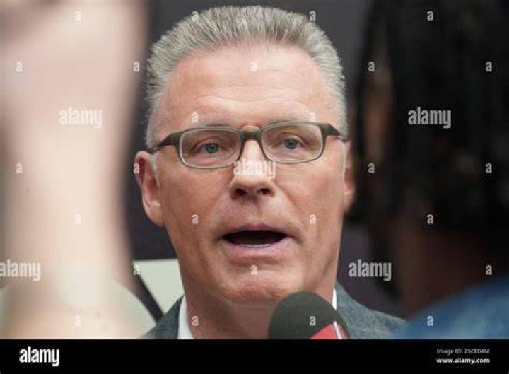 Former NFL player Howie Long, right, poses for photos with his wife