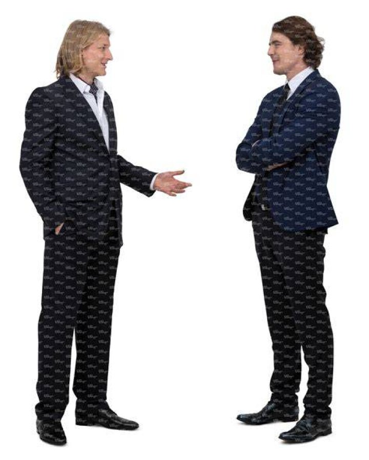 two men in suits standing next to each other